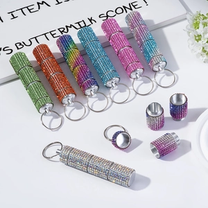 Sparkly rhinestone pill bottle keychains in various colors with secure screw-top lid