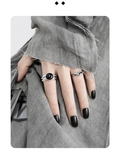 Detail of silver S925 geometric rings set featuring a black round agate stone inlay