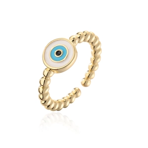 Macro shot of 18K gold plated evil eye ring with blue enamel and twisted band detail