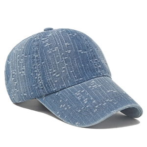 Distressed denim baseball cap in vintage blue with textured frayed finish and stiff brim