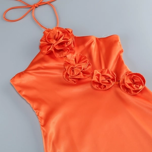Detail showing orange satin halter dress with three large 3D rose floral decorations