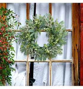 Detailed view of realistic eucalyptus wreath with berries on a vintage window frame