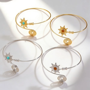 Detailed view of bohemian sun arm cuffs with turquoise insets and spiral ends