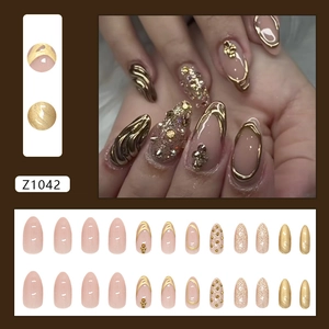 Sparkling champagne glitter almond fake nails set with gold accents and rhinestones