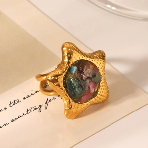 Detailed macro view of starfish ring with colorful natural stones on aesthetic card
