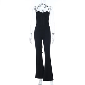 Close-up of black halter jumpsuit with slimming waist and flared leg on clear mannequin