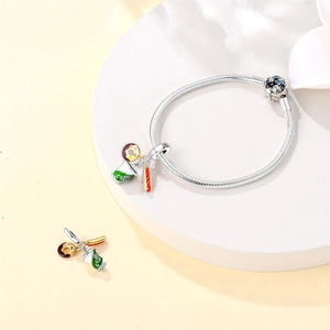Silver snake chain bracelet featuring enamel donut, hot dog, and coffee cup charms