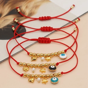 Handmade red cord evil eye friendship bracelets with heart and star gold pendants
