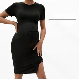 Detail of maternity dress with side slit and high elastic black knit fabric texture