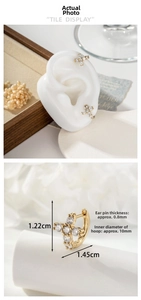 Detailed size specifications of gold cross earrings with zircon pavé and model display