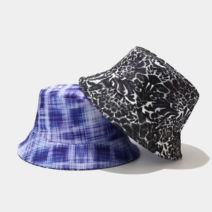 Reversible graffiti bucket hat with plaid and abstract patterns for sun protection
