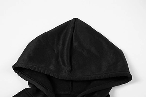 Macro detail of the hood seam and premium cotton fabric texture on a black hoodie