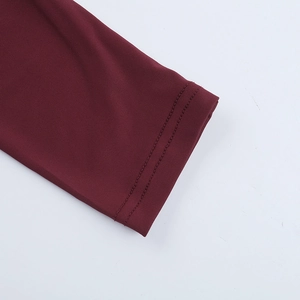 Detailed view of burgundy knit dress sleeve with durable double-stitched cuff