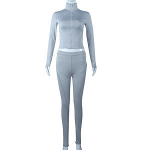 Front view of grey zip-up high neck long sleeve top and high waist yoga leggings set