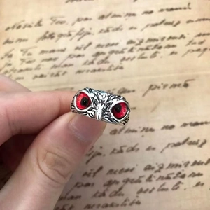 Vintage owl ring for women and men with red gemstone eyes on retro letter background