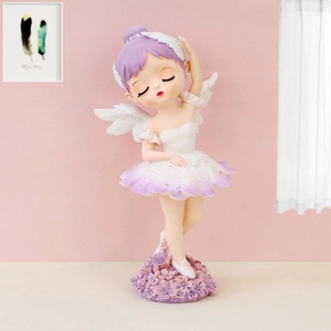Detail of cute purple ballet girl figurine with white wings on a flower base