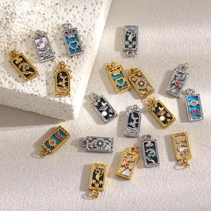 Detailed view of 18K gold plated stainless steel tarot card pendants with enamel inlay
