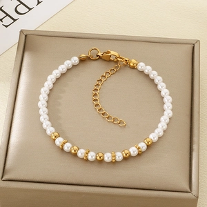 Detail of elegant pearl and gold bead bracelet featuring lobster clasp and extension chain