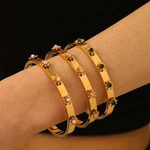 Three-piece 18K gold plated bangle set with floral designs, pearls, and colorful gemstones