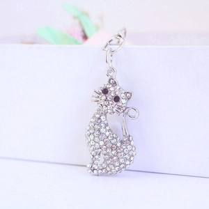 Sparkling silver crystal cat keychain with rhinestones hanging on a white decorative box