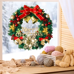 Close-up of a Christmas wreath with gold bells, red bow, and Merry Christmas sign