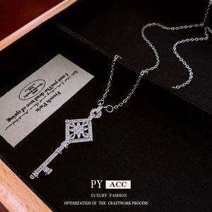 Elegant silver diamond rhombus flower key pendant necklace on black velvet display