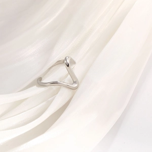 Polished silver stainless steel ring with elegant V-shaped wave design on white silk fabric