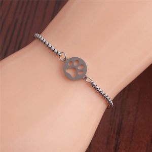 Adjustable stainless steel chain bracelet with silver paw print charm on male wrist