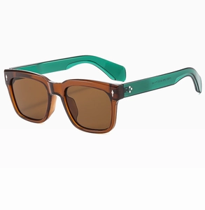 Detail view of brown translucent sunglasses frame and green arms with metal star accents