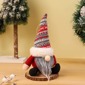Detail showing hand-knitted hat and long white beard of a festive Christmas gnome plush
