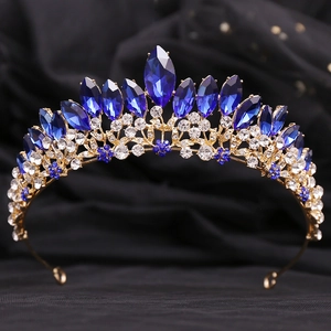 Detailed macro shot of golden alloy bridal crown featuring blue marquise crystals and rhinestones