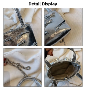 Detail view of silver mini handbag with metallic bow accents and bead chain strap