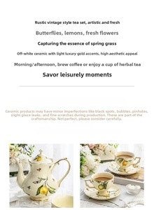 Detail of cream ceramic teapot and cup set with lemon and butterfly pattern