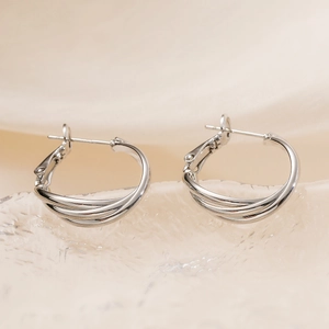 Elegant silver twisted geometric hoop earrings with polished intertwined metal design
