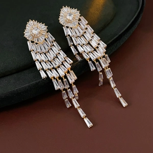 Detailed shot of gold plated geometric floral earrings with dangling zircon tassels