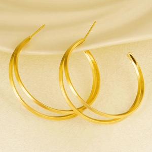 Detailed macro view of gold double hoop earrings in polished stainless steel design