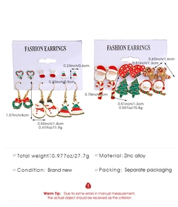 Macro view of Christmas earring set with Santa, snowmen and festive enamel details