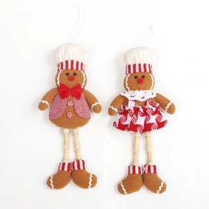 Plush gingerbread man and woman doll ornaments with striped hats and wooden legs