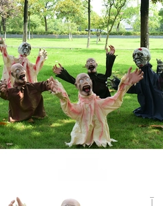 Detail of five different outdoor Halloween zombie decorations with torn fabric outfits