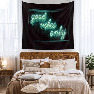 Detail showing neon 'good vibes only' script on black bohemian wall tapestry decor