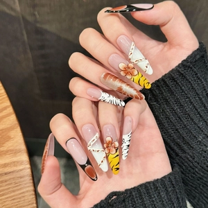 Long press-on nails with 3D floral carvings, leopard prints and amber texture design