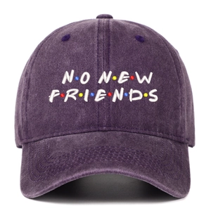 Detailed close-up of NO NEW FRIENDS embroidery on a vintage washed purple cotton baseball cap
