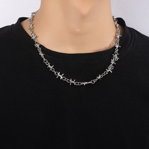 Punk silver barbed wire necklace for men and women shown on a black t-shirt model