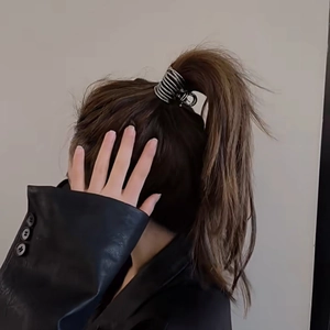 Silver spiral metal hair claw clip for high ponytail on brunette model in black leather jacket