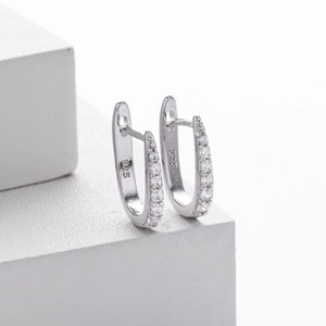 Detail showing 925 sterling silver hallmark on single row zircon U-shaped hoop earrings