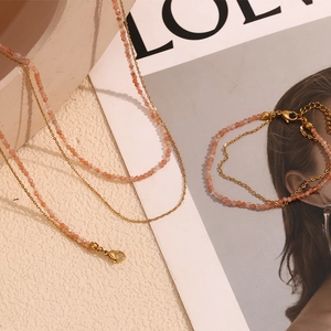 Close-up of 18K gold-plated beaded necklace set with sunstone and lobster clasp