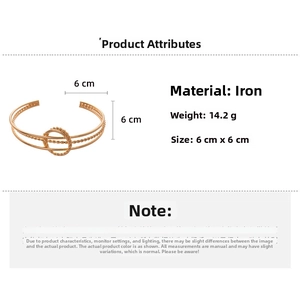 Detail view of rose gold double-layered cuff bracelet with twisted rope center ring detail