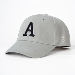 Detail of grey cotton baseball cap showing 3D letter A embroidery and side cross pattern