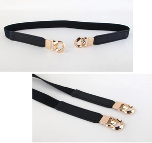 Detail of black elastic belt featuring polished gold-tone interlocking chain buckle