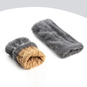 Detailed view of cable knit hand warmers showing brown exterior and plush grey lining